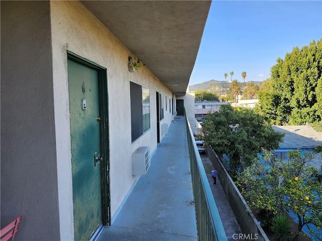 balcony with a wall unit AC and a mountain view