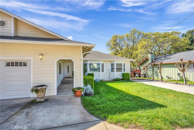 view of front of house featuring a garage and a front lawn