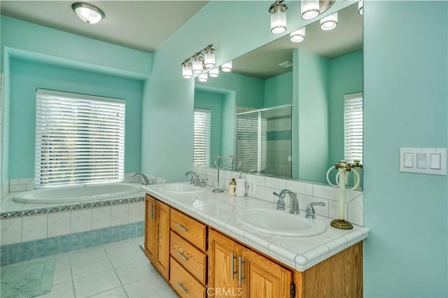 bathroom with separate shower and tub, vanity, and tile patterned floors