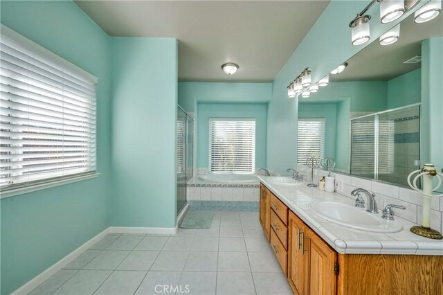 bathroom featuring plus walk in shower, tile patterned floors, and vanity