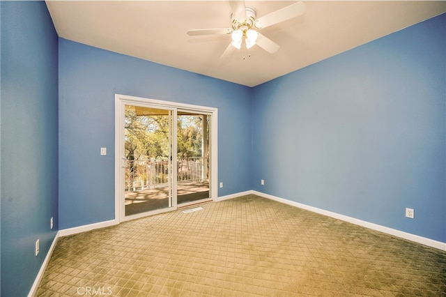 carpeted spare room featuring ceiling fan