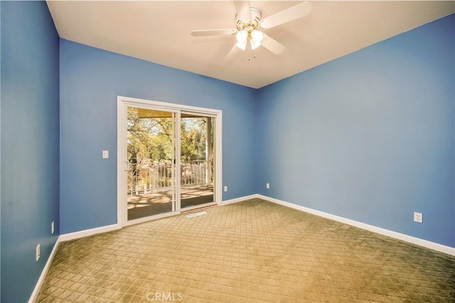 carpeted spare room featuring ceiling fan