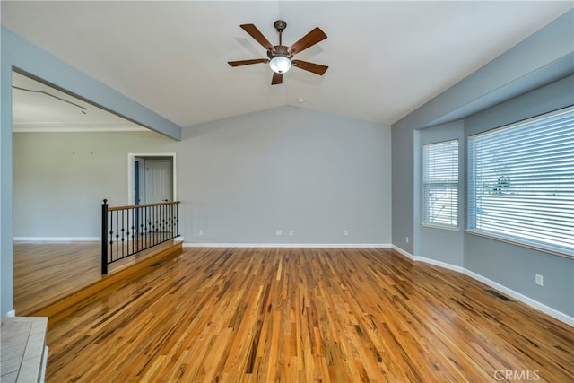 empty room featuring light hardwood / wood-style floors, lofted ceiling, and ceiling fan