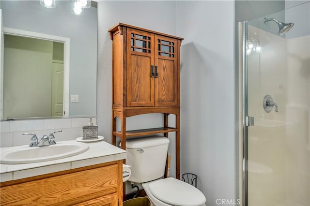 bathroom with an enclosed shower, vanity, decorative backsplash, and toilet