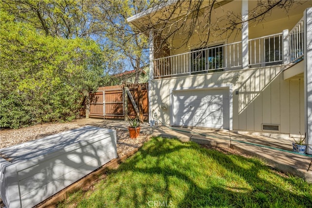 exterior space with a balcony and a garage