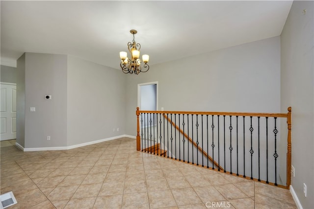 unfurnished room featuring an inviting chandelier