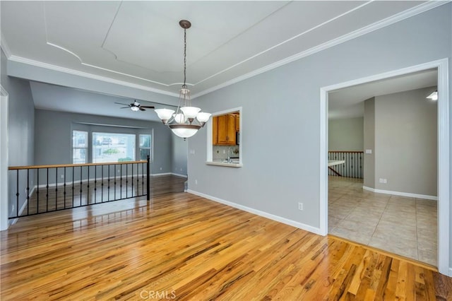 unfurnished dining area with light wood-type flooring, ornamental molding, sink, and a notable chandelier