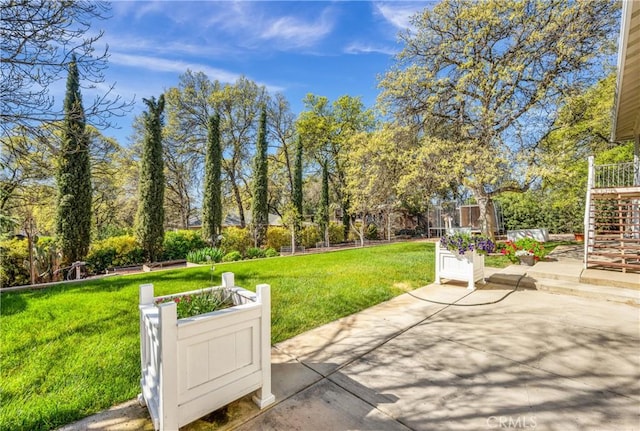 view of property's community with a patio area and a lawn