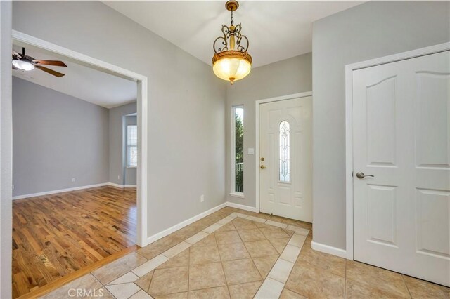 entrance foyer featuring ceiling fan and light tile patterned floors