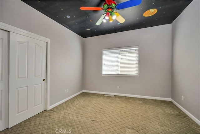 carpeted empty room with ceiling fan