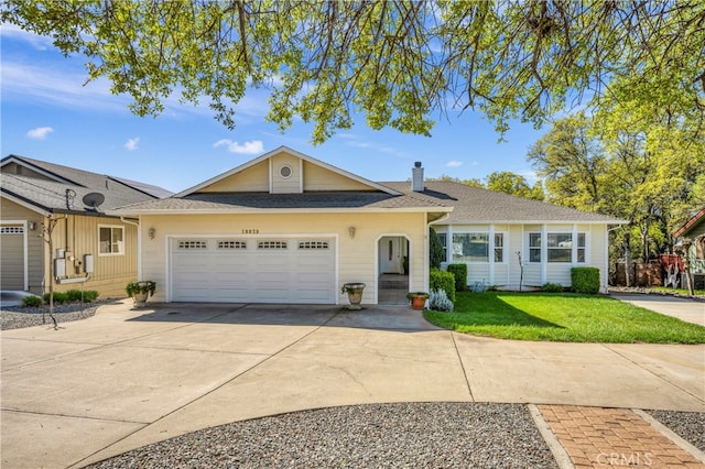 ranch-style home featuring a garage and a front yard