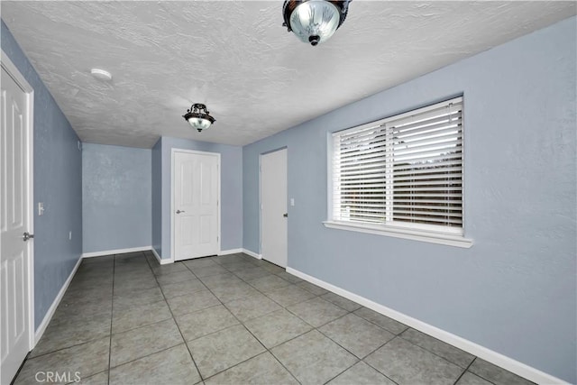 interior space featuring a textured ceiling and tile patterned floors