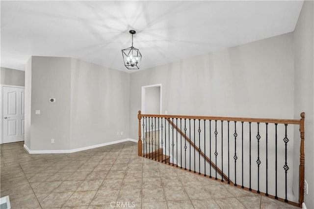 spare room with an inviting chandelier