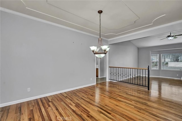 spare room featuring ornamental molding, ceiling fan with notable chandelier, and wood-type flooring