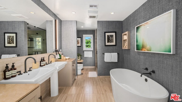 full bathroom featuring vanity, plus walk in shower, toilet, and tile patterned floors