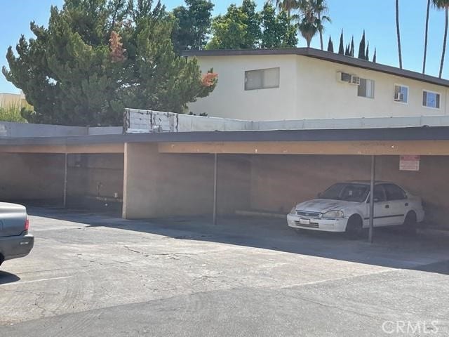 view of vehicle parking featuring a carport