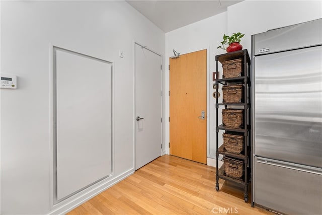 hallway with light hardwood / wood-style floors