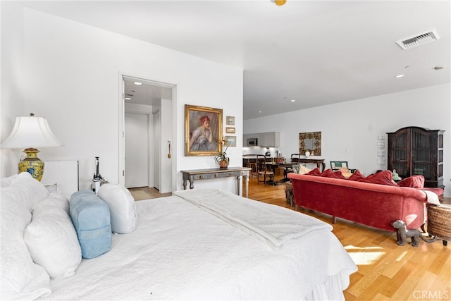 bedroom with light hardwood / wood-style floors