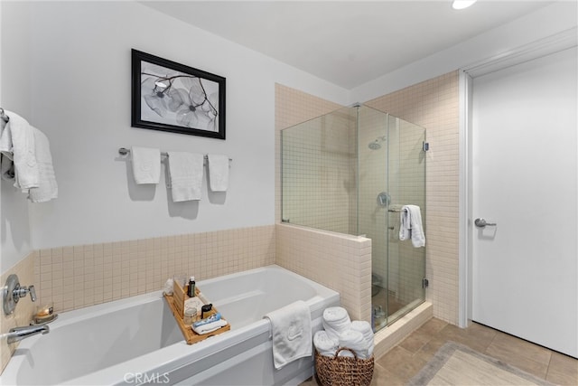 bathroom with tile patterned floors and independent shower and bath