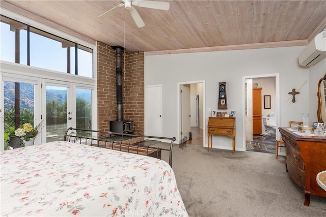 carpeted bedroom featuring wooden ceiling, connected bathroom, an AC wall unit, and ceiling fan