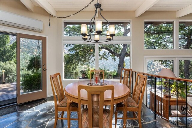 sunroom featuring an inviting chandelier, beamed ceiling, and a wall mounted air conditioner