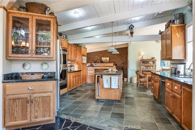 kitchen with stainless steel appliances, vaulted ceiling with beams, hanging light fixtures, a kitchen island, and sink