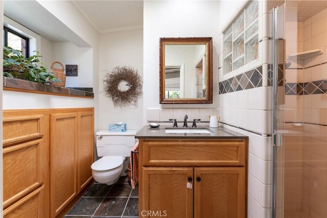 bathroom featuring toilet, walk in shower, and vanity