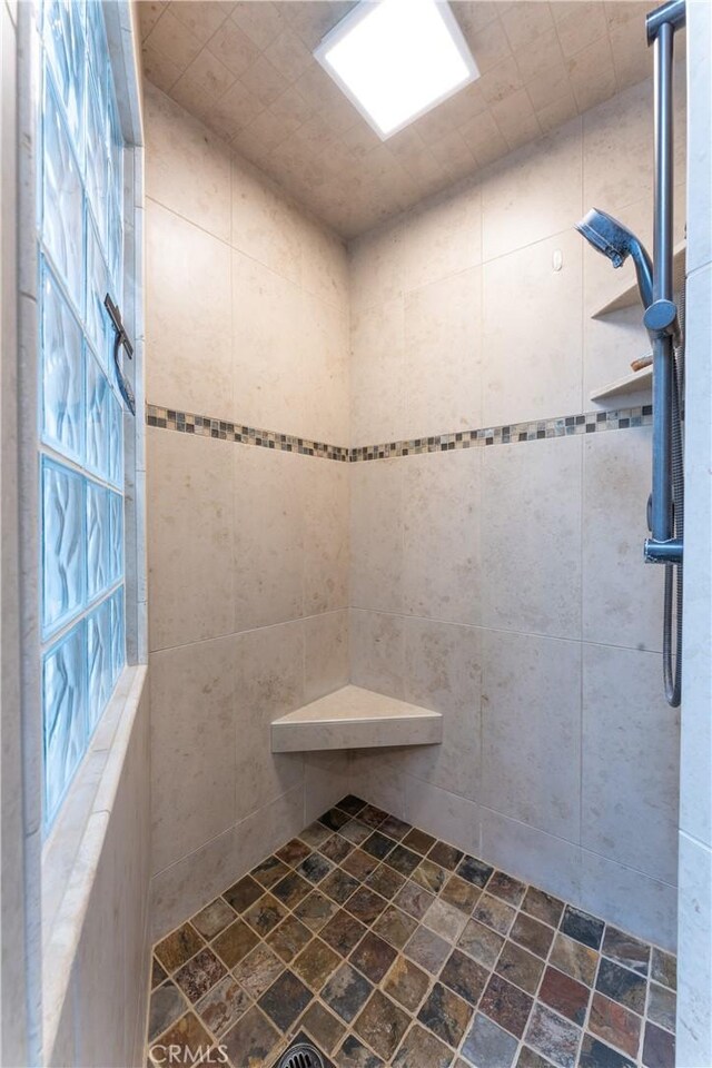 bathroom with tiled shower