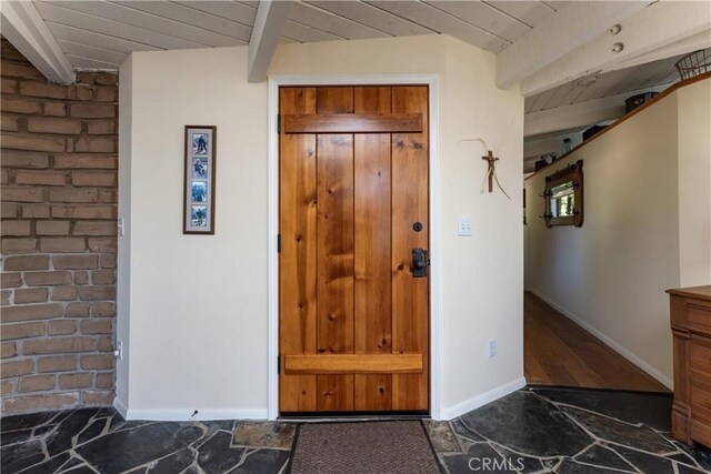 entrance foyer with wooden ceiling and beamed ceiling