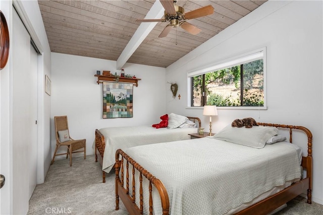 bedroom with light carpet, wooden ceiling, ceiling fan, a closet, and lofted ceiling with beams