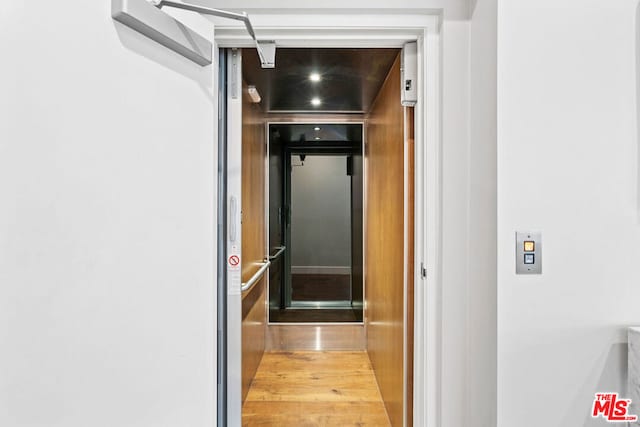 corridor with light wood-type flooring