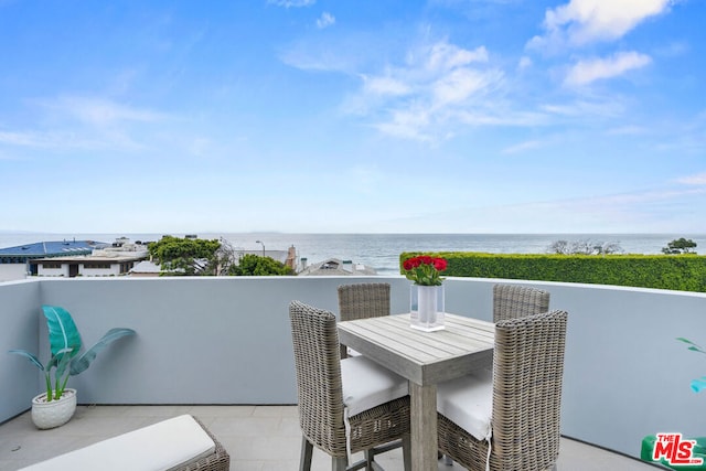 balcony featuring a water view