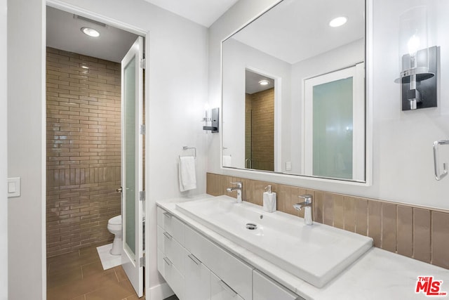 bathroom with vanity, toilet, and tile patterned floors