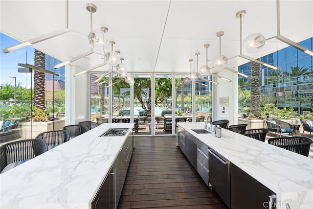 exterior space featuring light stone countertops, hanging light fixtures, a chandelier, and dark hardwood / wood-style floors