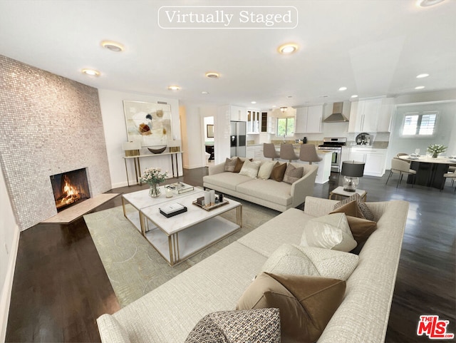 living room featuring a fireplace and dark hardwood / wood-style flooring