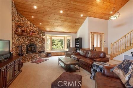 carpeted living room with wood ceiling, a fireplace, and high vaulted ceiling