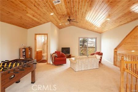 game room with carpet flooring, lofted ceiling, ceiling fan, and wooden ceiling