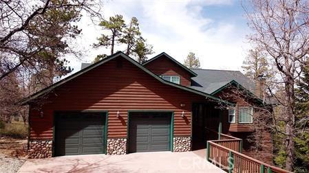 log home featuring a garage