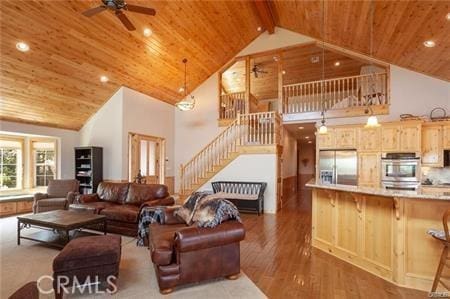 living room featuring beam ceiling, wood ceiling, dark wood-type flooring, and high vaulted ceiling