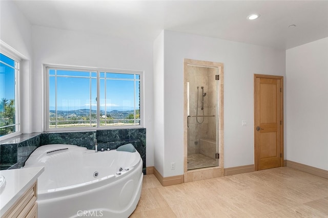 bathroom with plus walk in shower, tile patterned flooring, and vanity