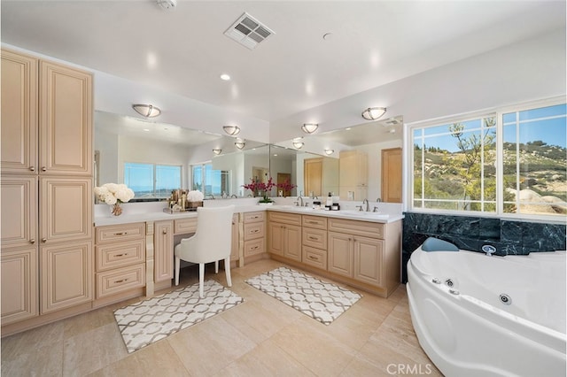 bathroom featuring vanity, a tub, and tile patterned floors