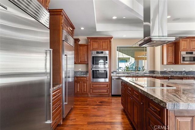 kitchen featuring sink, a kitchen island, island exhaust hood, stainless steel appliances, and dark hardwood / wood-style floors