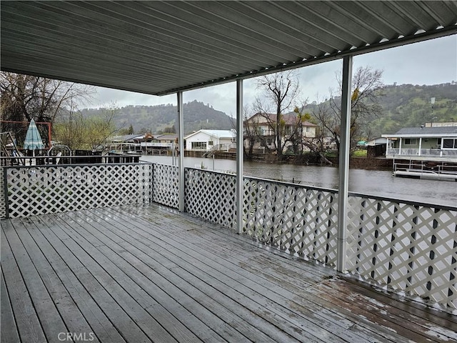 wooden deck featuring a residential view and a water view