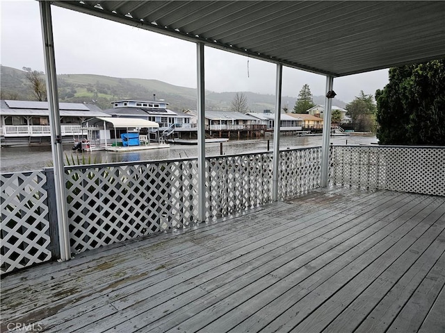 wooden terrace featuring a residential view and a water and mountain view