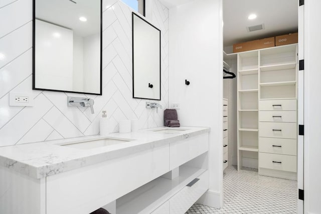 spacious closet with sink and light tile patterned flooring