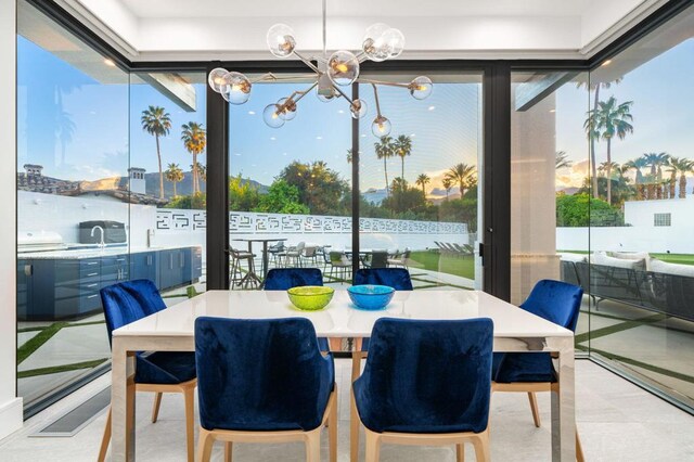 sunroom featuring an inviting chandelier