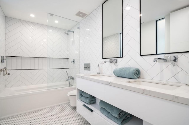 full bathroom featuring shower / bath combination with glass door, tile patterned floors, vanity, tile walls, and toilet