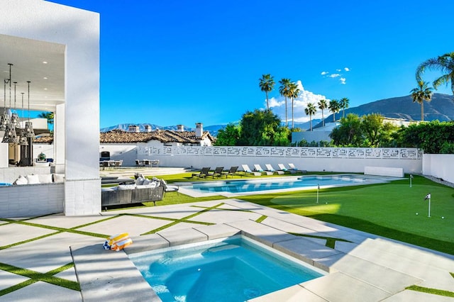 view of pool featuring a mountain view and a hot tub