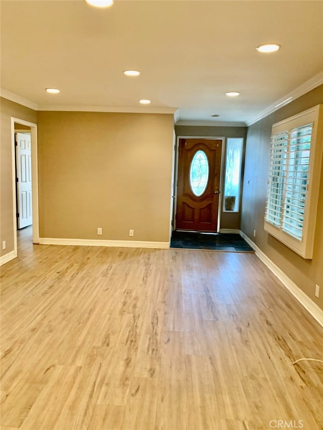 entryway with crown molding and hardwood / wood-style floors