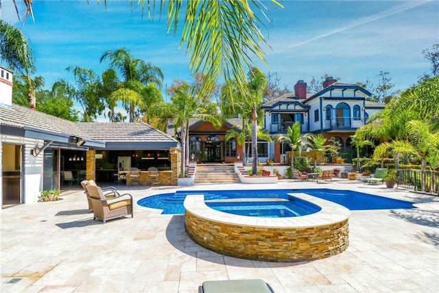 view of swimming pool with a patio area and an in ground hot tub